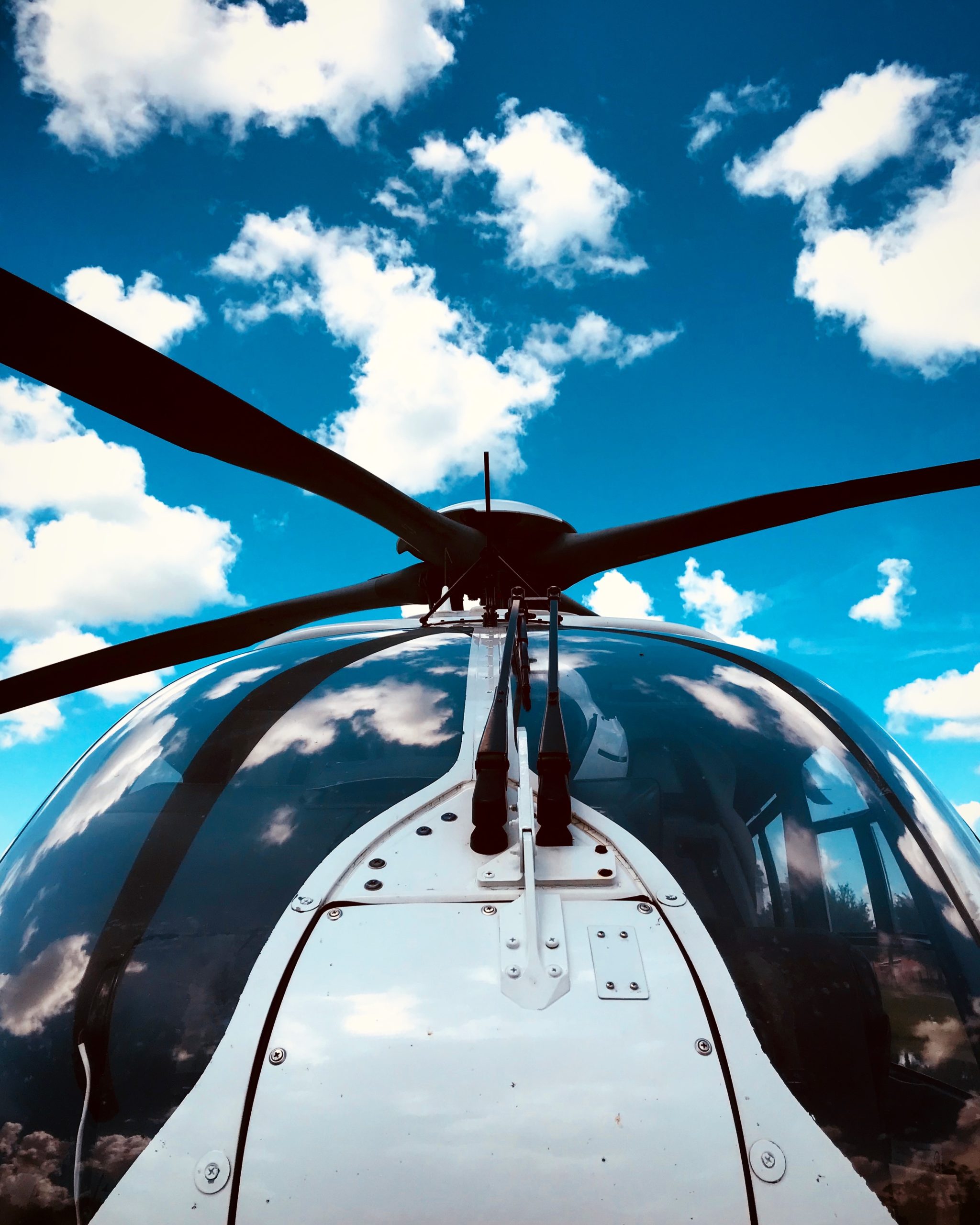 Nose of helicopter with sky in background. 